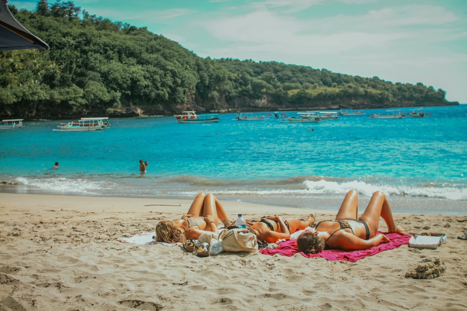 Mädels liegen an Strand und sonnen sich