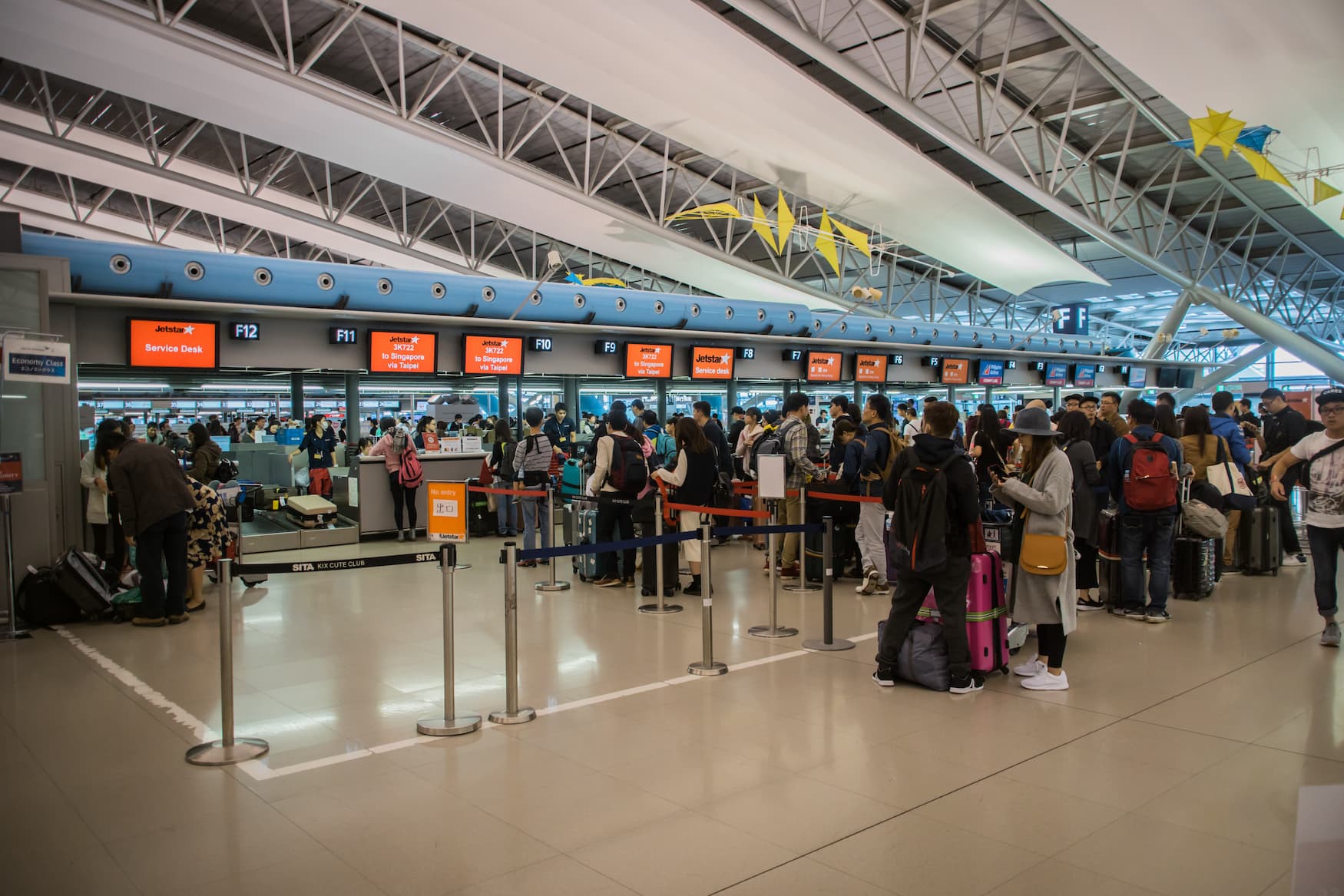 Warteschlange am Check in Schalter am Flughafen in Osaka, Japan