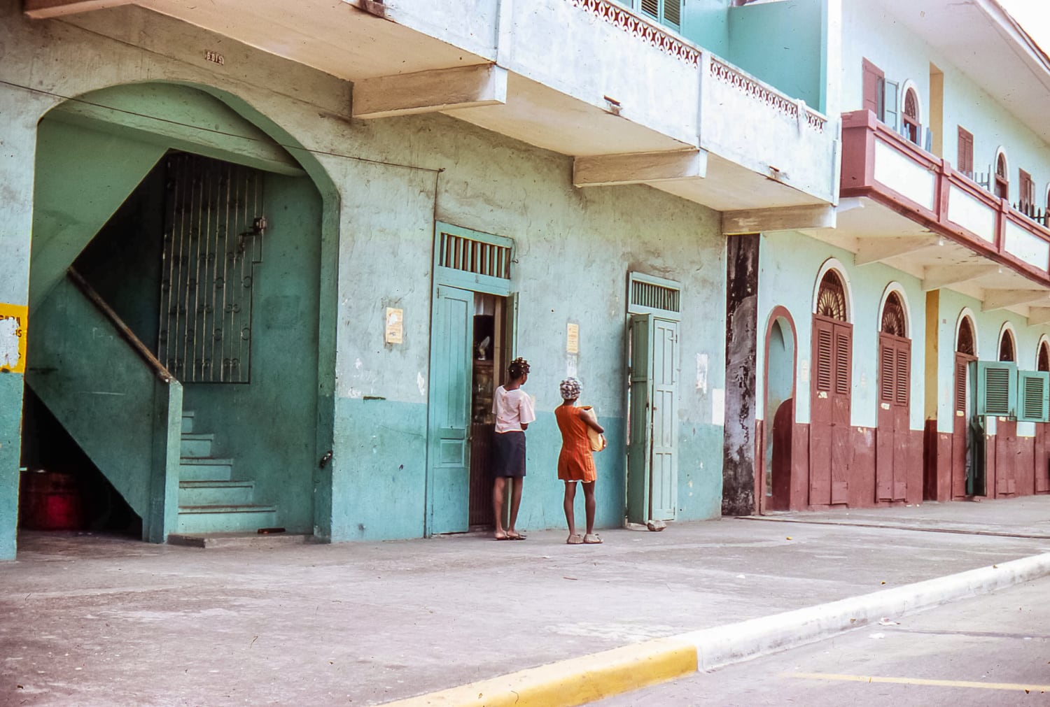 Pastellfarbene Häuser in Panama mit Frauen.