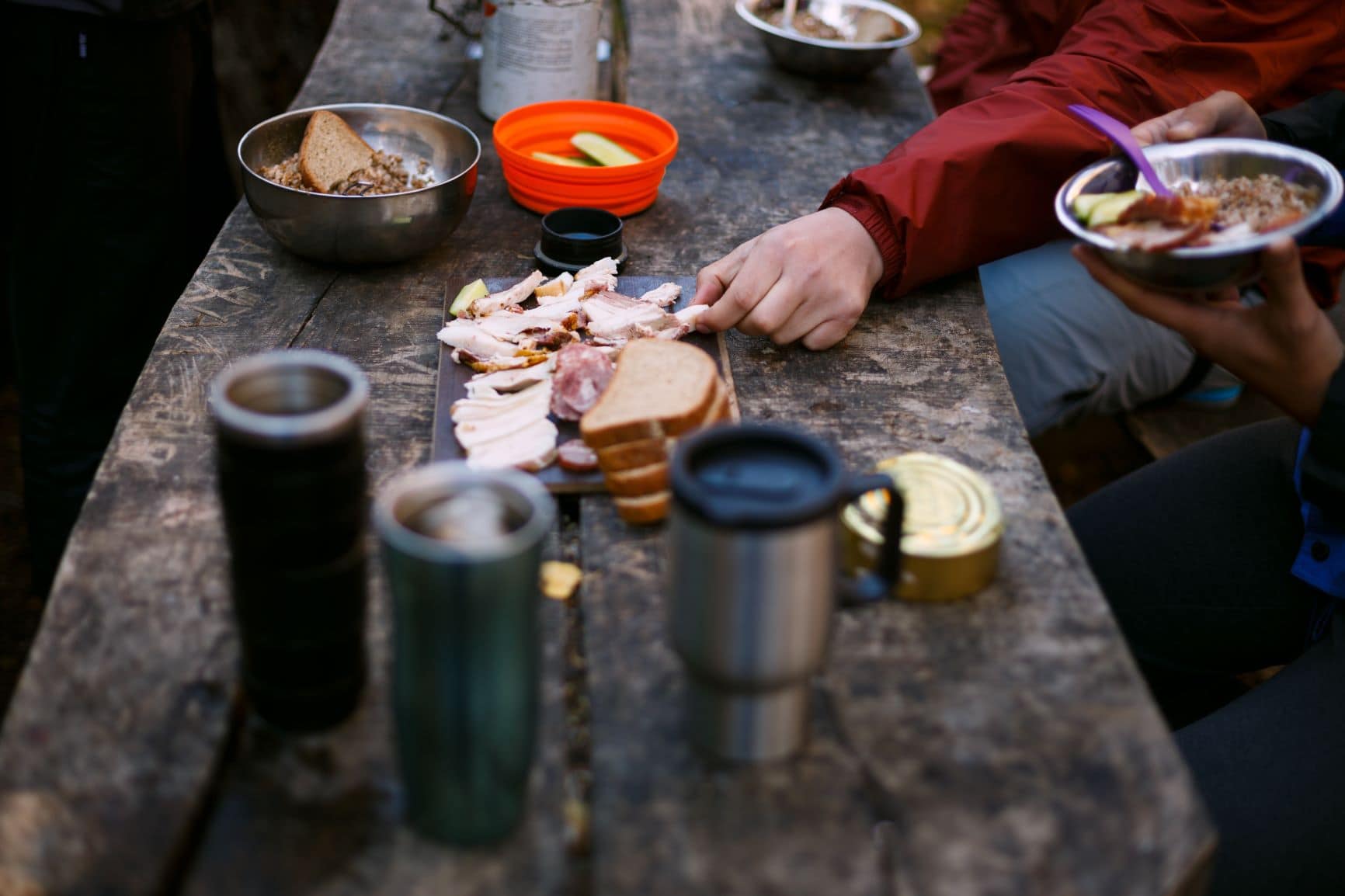 Holztisch bedeckt mit Brot und Wurst
