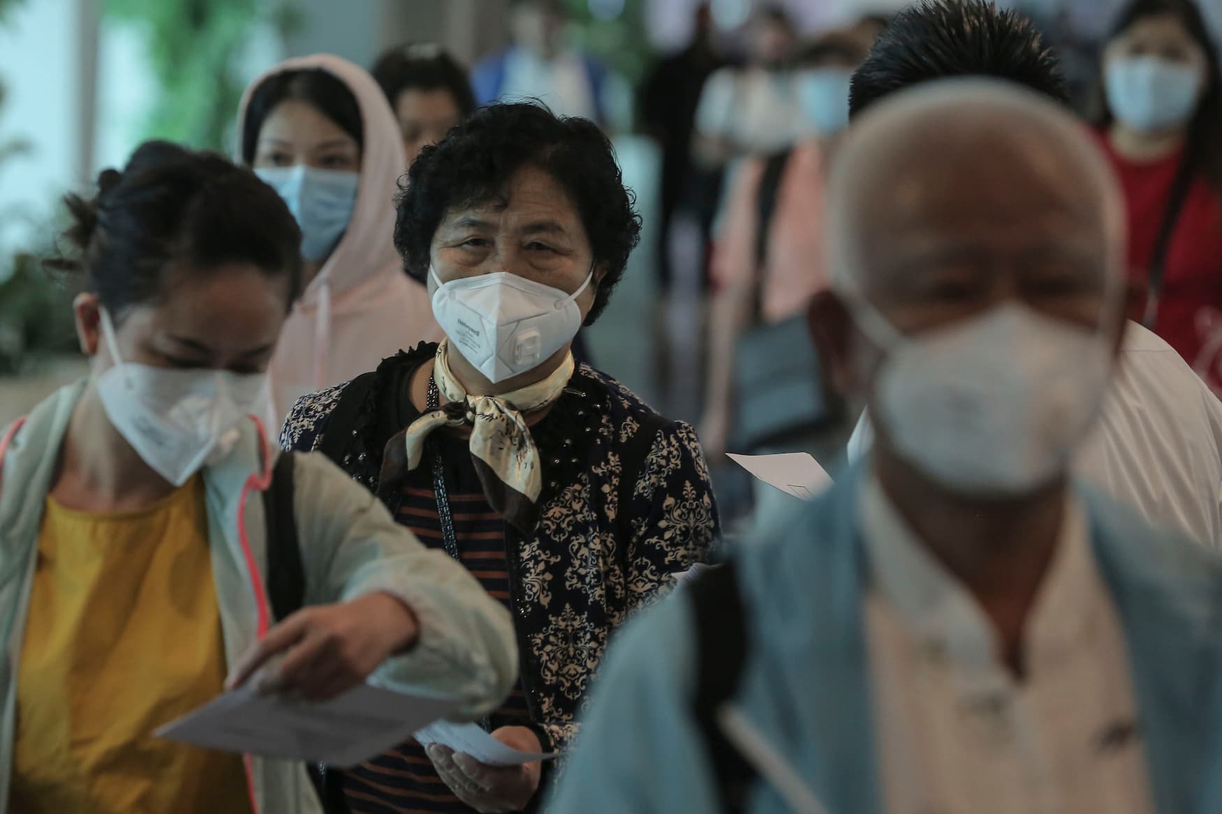 Touristen tragen am Flughafen Mundschutz als Vorsichtsmaßnahme gegen das Coronavirus.