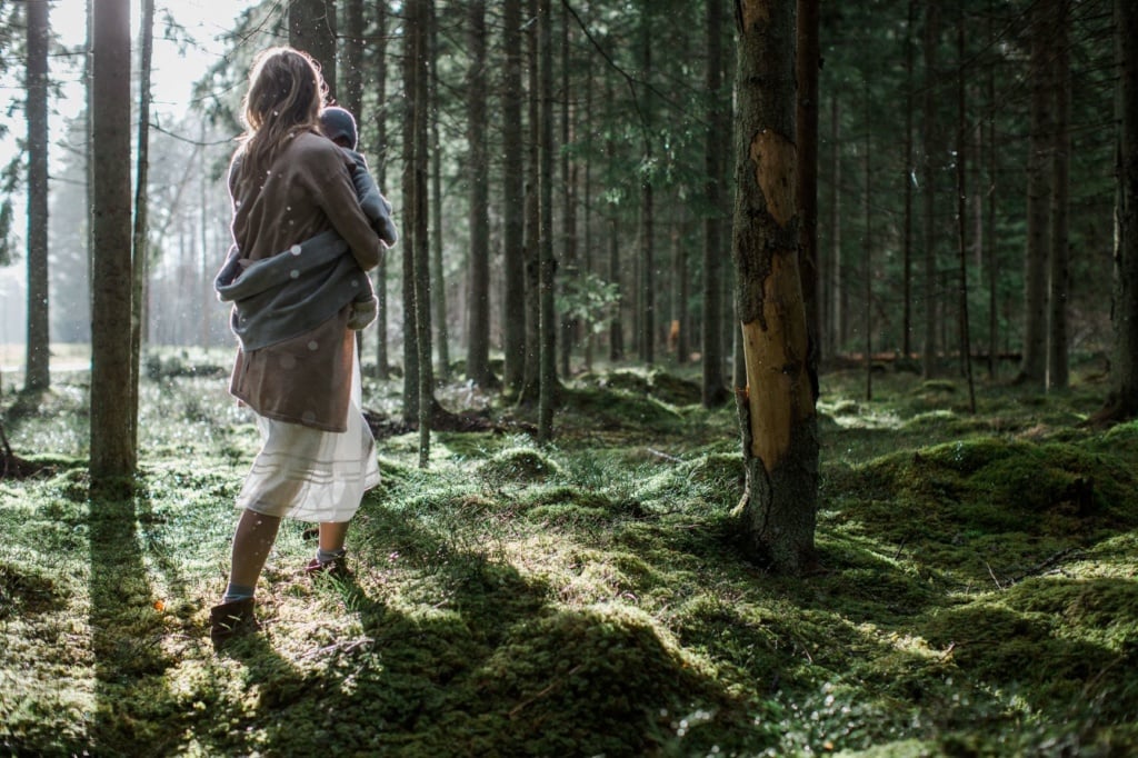 Frau mit Baby in Arm in Estlands Wald