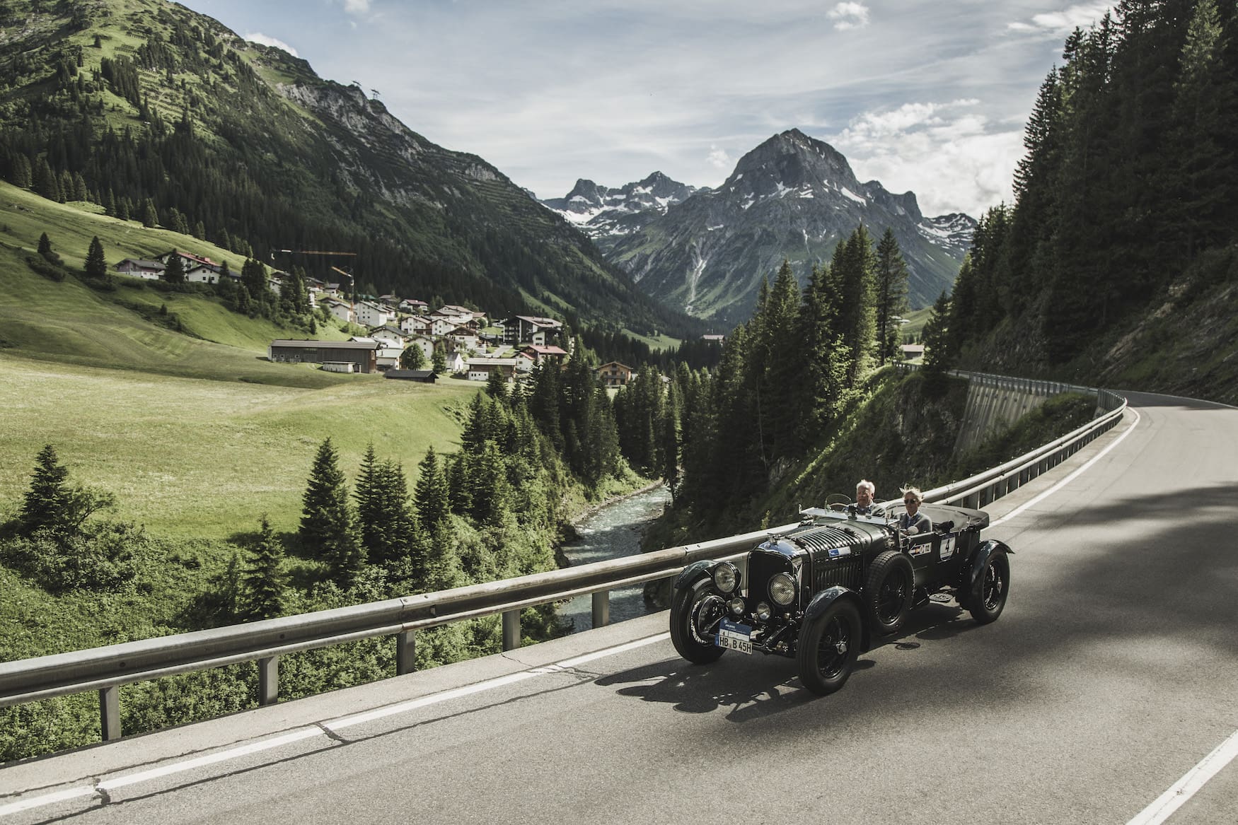 Älteres Pärchen unternimmt eine Fahrt mit einem Oldtimer durch die österreichischen Landschaften bei Lech