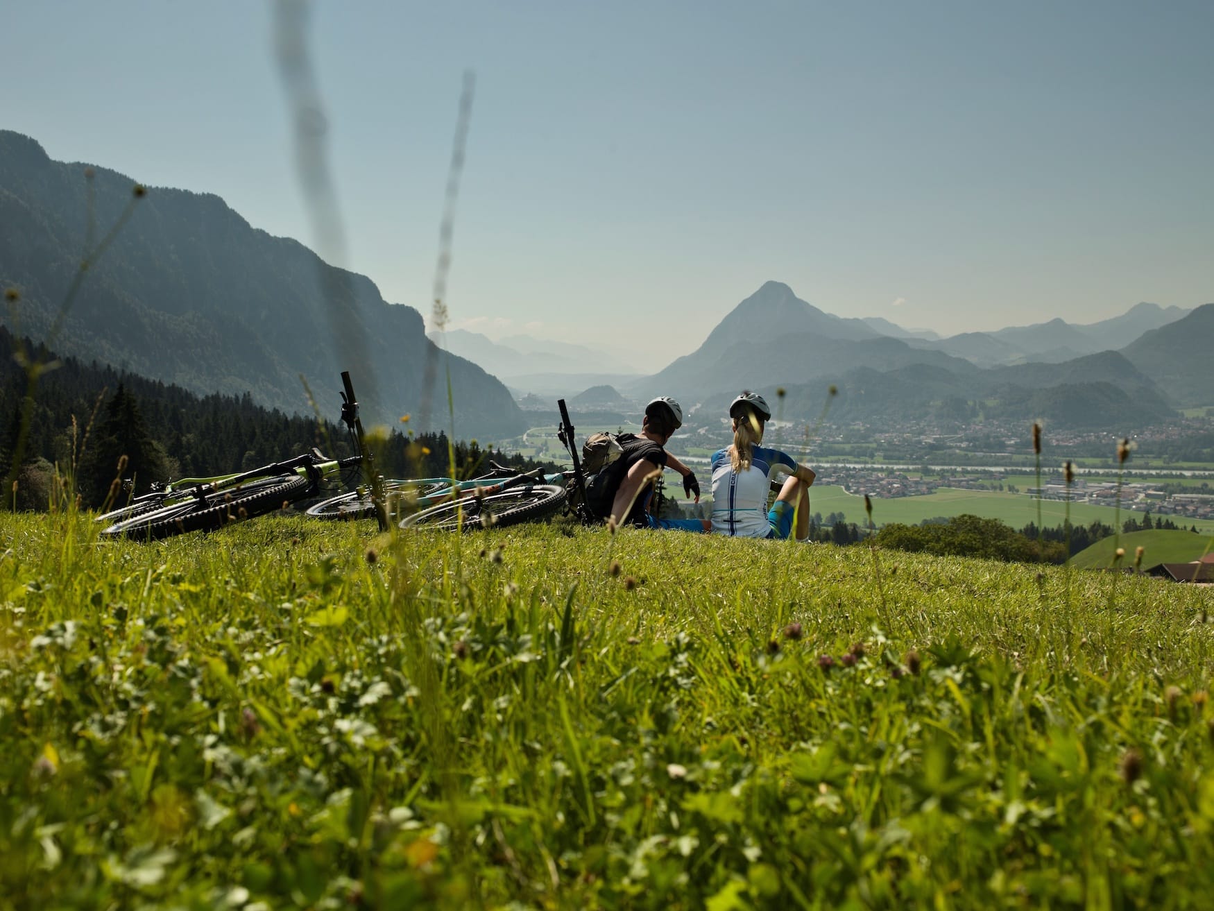 Radfahrer machen eine Pause mit Blick über das Inntal