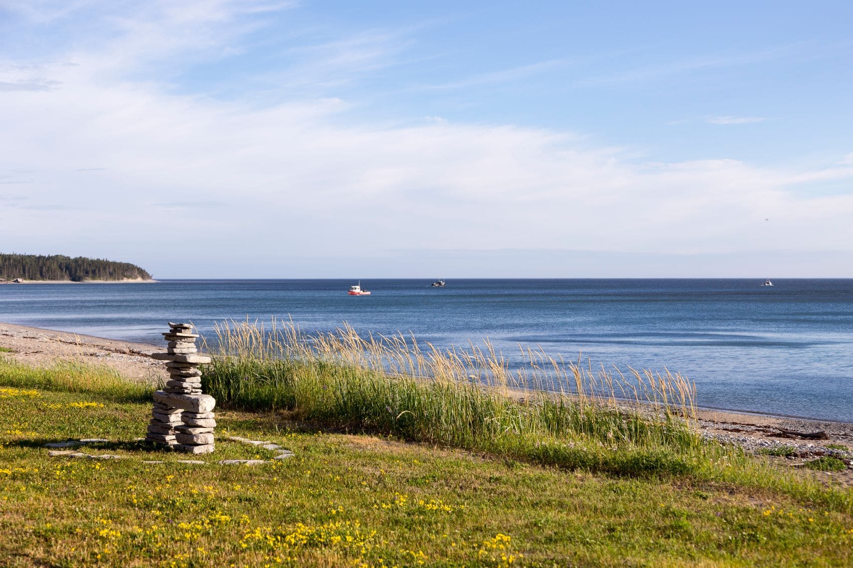 Large Inukshuk built on the St. Lawrence River shore