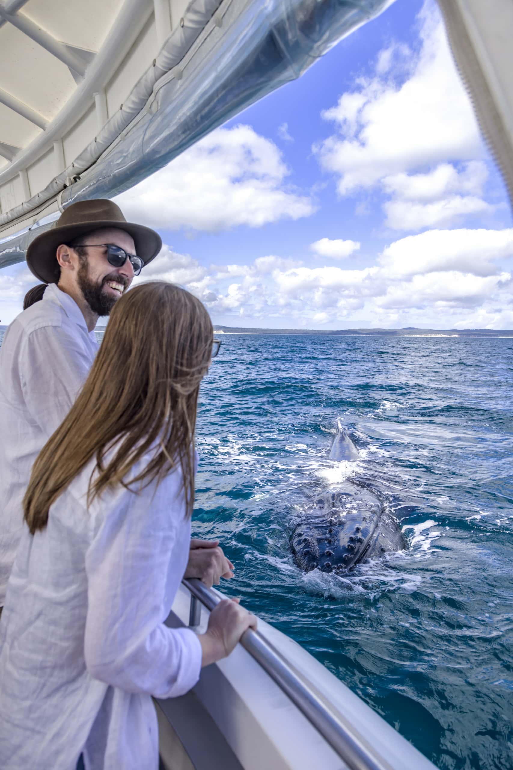 Glückliche Ausflügler auf einem Whale Watching Trip in der Hervey Bay.