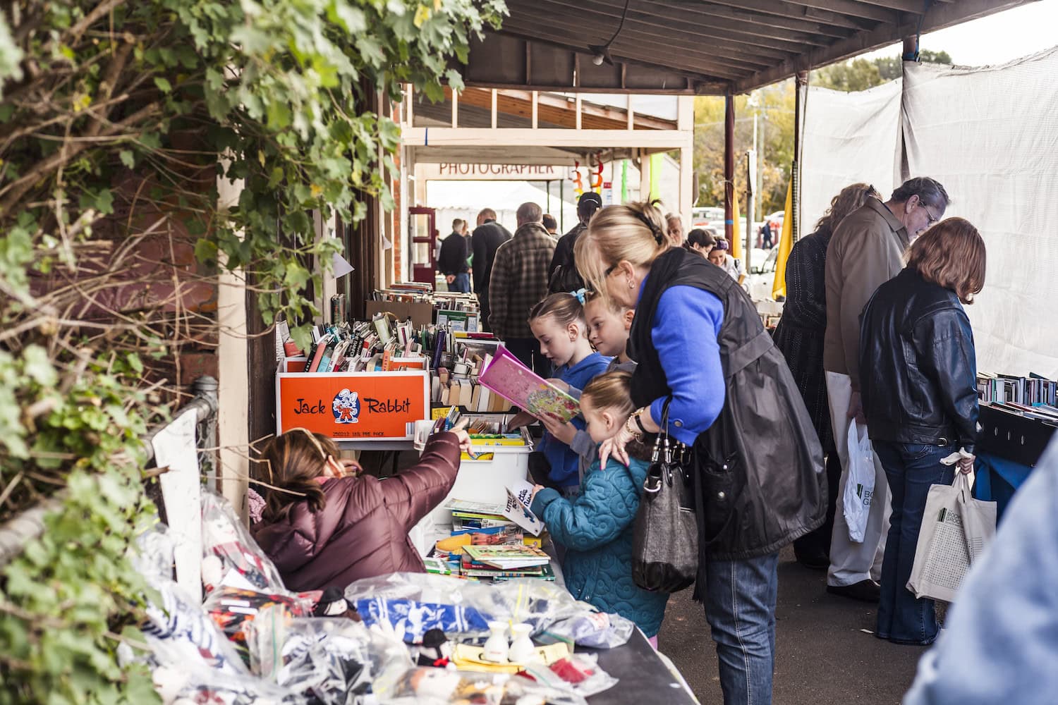 Menschen stehen beim Booktown Festival mit Büchern in der Hand bei Clunes
