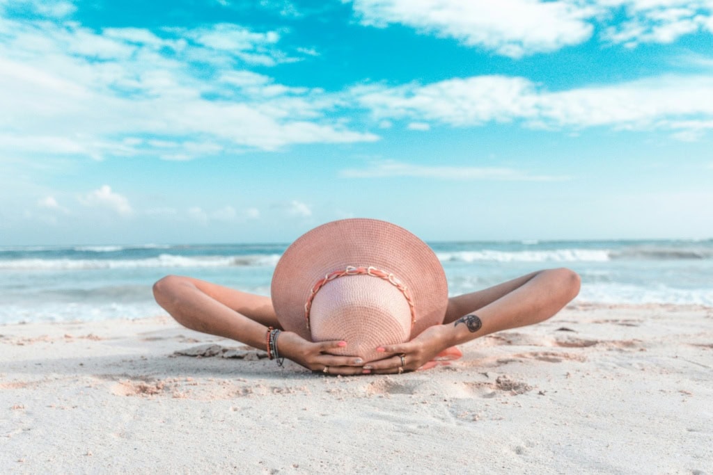 Frau am Strand: Diese warmen Reiseziele locken im Mai!