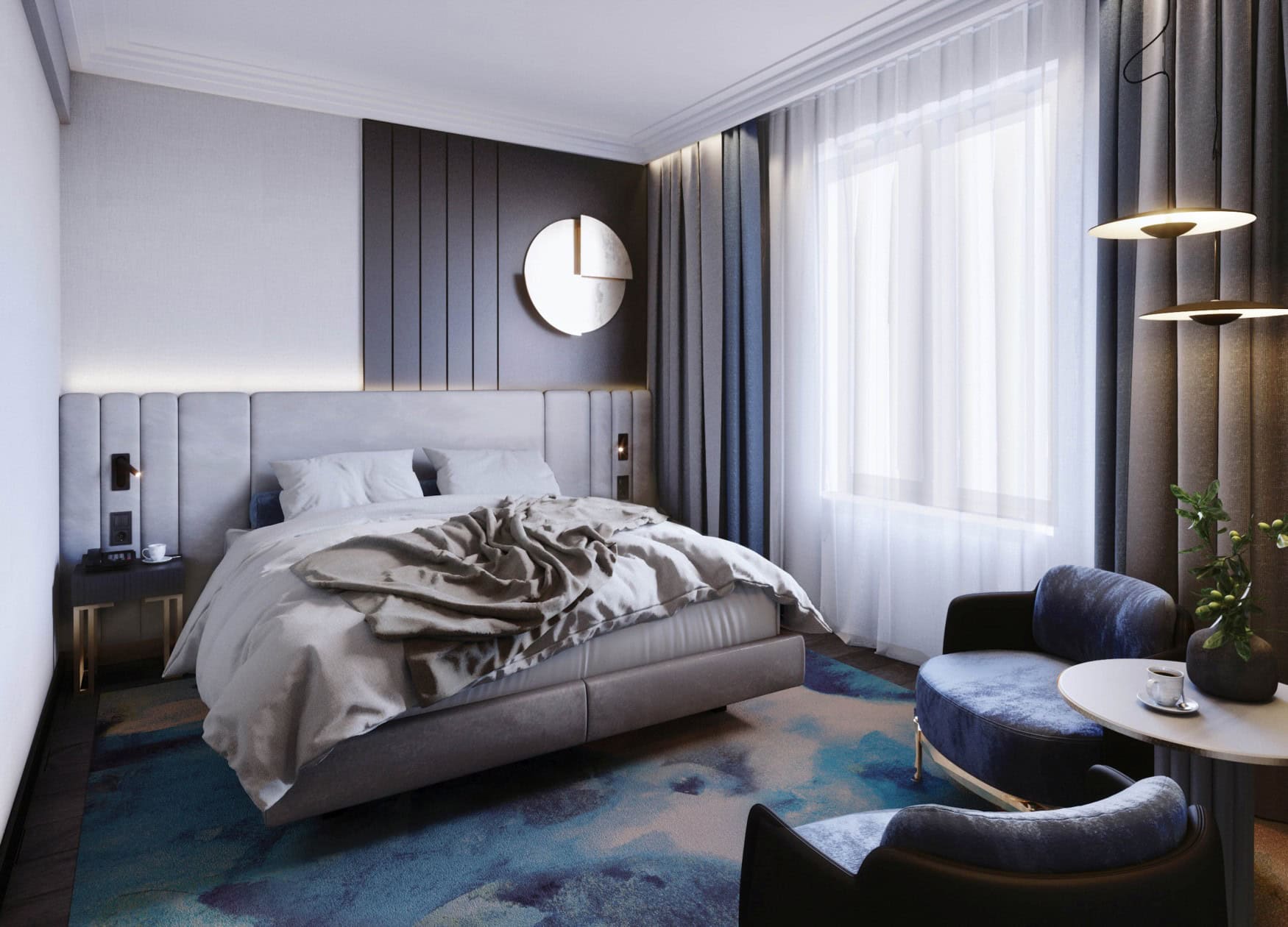 Ein in Grau, Gold und Blau gehaltenes Zimmer im Garamond, a Tribute Portfolio Hotel in Krakau; mittig ein Doppelbett, rechts zwei blaue Sessel und ein runder Beistelltisch