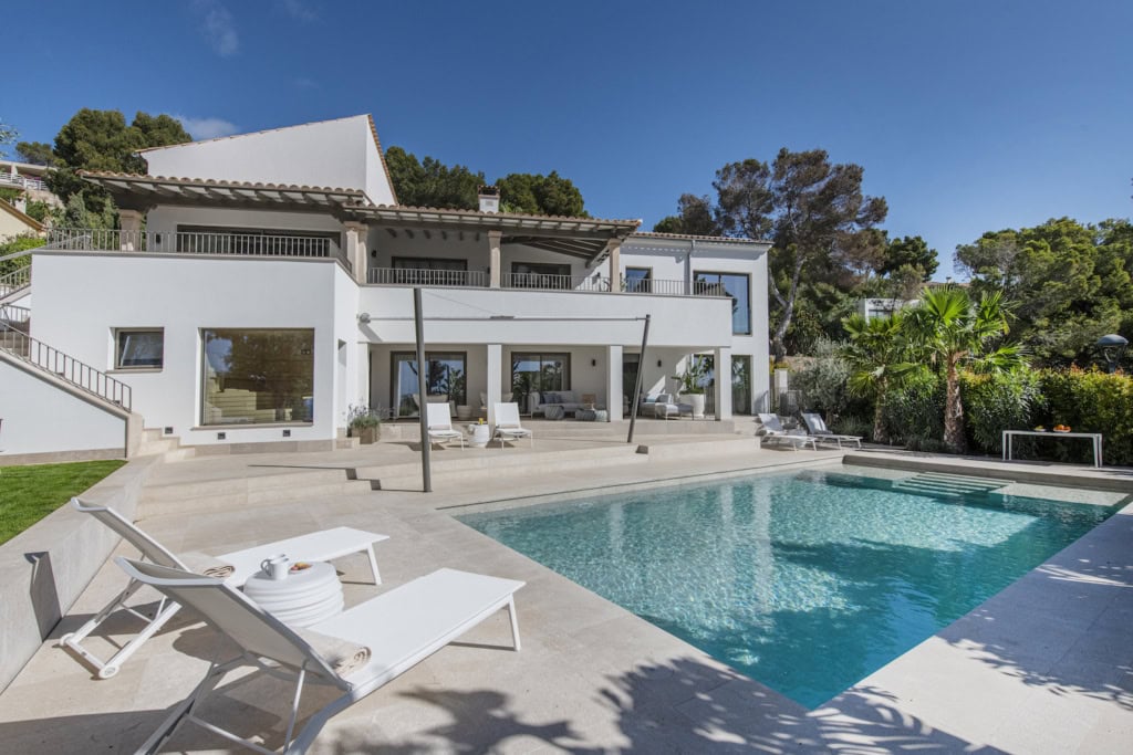 A modern villa with a swimming pool and patio.