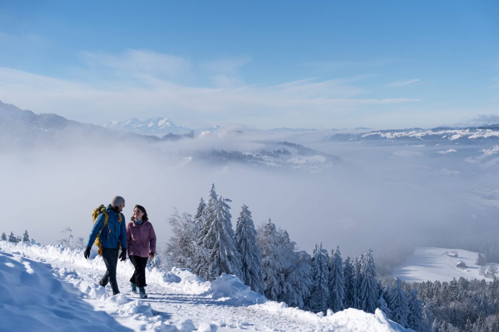 ein Paar wandert durch den Schnee in Oberstaufen